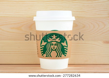 Bangkok, Thailand - May 06, 2015 : Starbucks take away coffee cup with brand logo on sleeve, Starbucks is one of the most world famous coffeehouse chains from USA