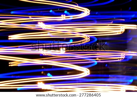 Colorful light streaks at night (long exposure shot) - abstract background
