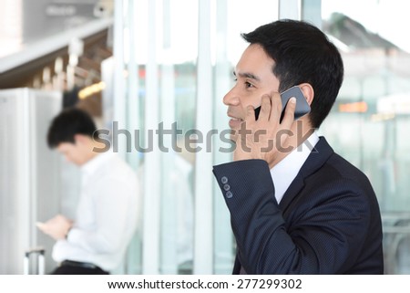 Asian businessman using cell phone - soft focus