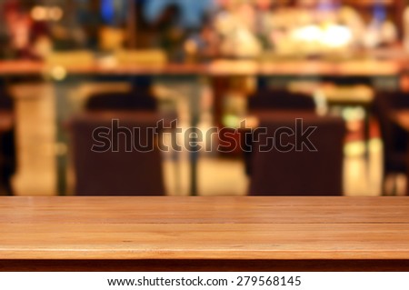 Wood table top in restaurant - can be used as background for display or montage your products