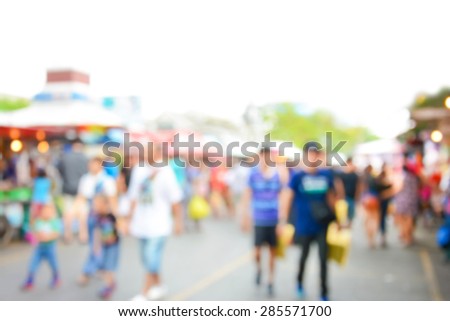 Blurred crowd walking on the street, outdoor market - can be used as blur background