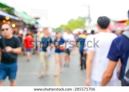 Blurred crowd walking on the street, outdoor market - can be used as blur background