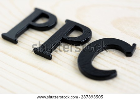 PPC (or Pay Per Click) sign on wood background, internet (online) marketing and advertising concepts
