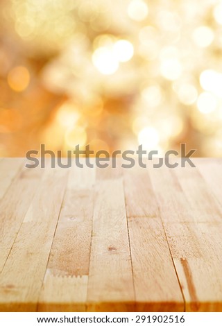 Wood table top on shiny bokeh gold background, poster size proportion - can be used for display or montage your products