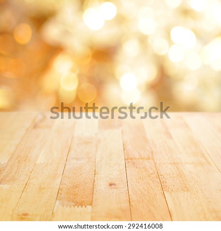 Wood table top on shiny bokeh gold background - can be used for display or montage your products