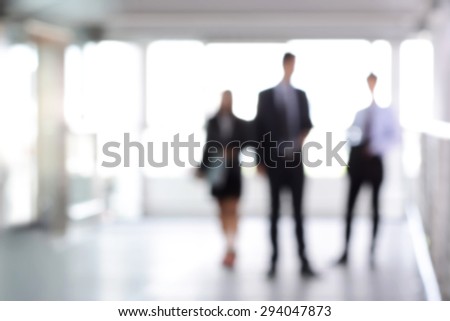 Blurred business people standing in building hall , can be used as abstract background