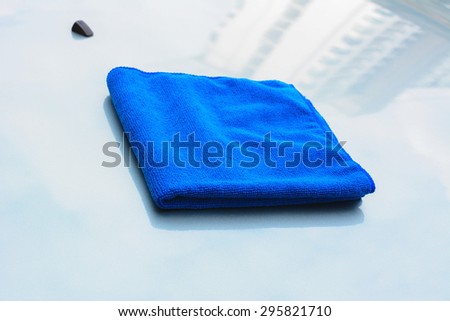 Blue microfiber cleaning cloth on car bonnet