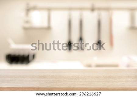 Wood table top on blur kitchen background - can be used for display or montage your products