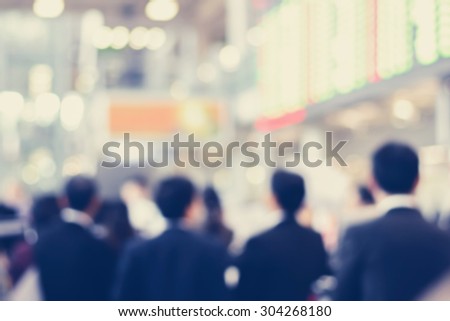 Blurred back view of businessmen inside airport terminal