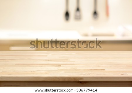 Wood table top (as kitchen island) on blur kitchen background - can be used for display or montage your products