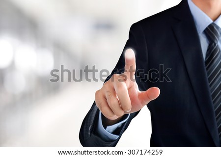 Businessman hand touching empty virtual screen, modern business background concept - can be used for montage your text or pictures at the finger
