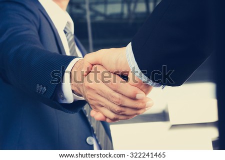 Handshake of businessmen - greeting, dealing, mergers and acquisition concept