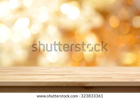 Wood table top on golden bokeh abstract background  - can be used for montage or display your products