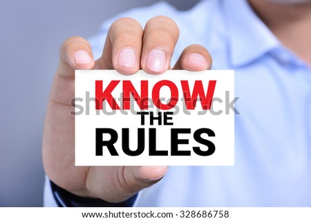 KNOW THE RULES, message on the card shown by a man