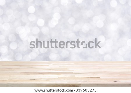 Wood table top on shiny white bokeh abstract background - can be used for display or montage your products