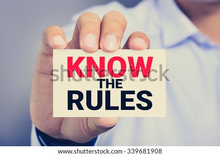 KNOW THE RULES, message on the card shown by a man