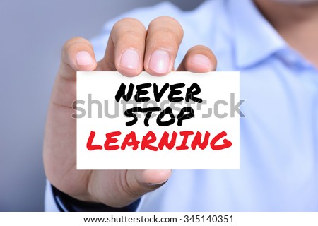 NEVER STOP LEARNING, message on the card held by a man hand