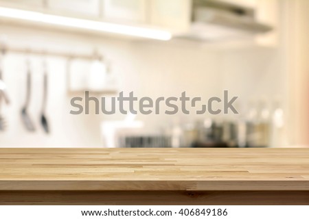Wood table top (as kitchen island) on blur kitchen background - can be used for display or montage your products