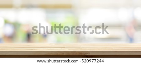 Wood table top on blur kitchen window background, panoramic banner - can be used for display or montage your products (or foods)