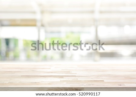 Wood table top on blur kitchen window background - can be used for display or montage your products (or foods)