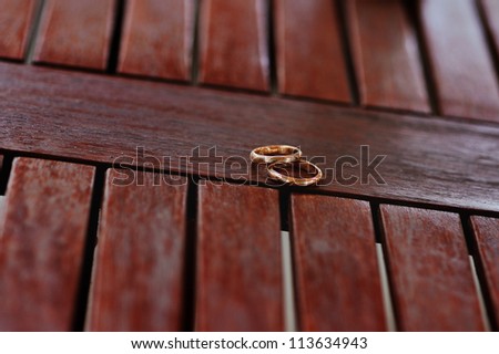 wedding rings  on a wood surface