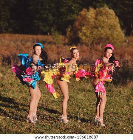 three dancing girls in autumn