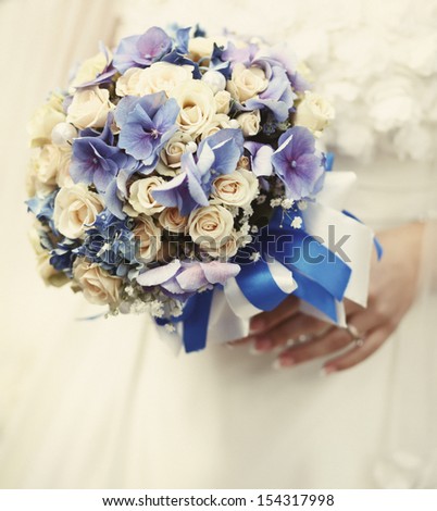 young bride holding a wedding bouquet