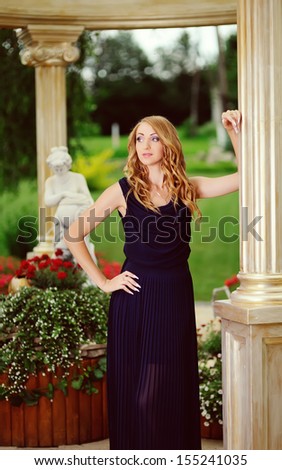fashion lady in blue dress posing in garden made in  Greek style