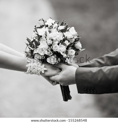 hold me, marry me, hands of a wedding  couple in black and white