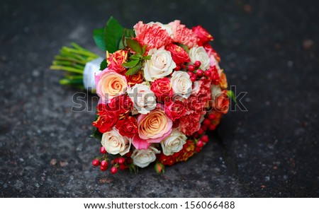 Bouquet of various flowers on asphalt