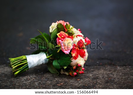 beautiful Bouquet of various flowers on an asphalt