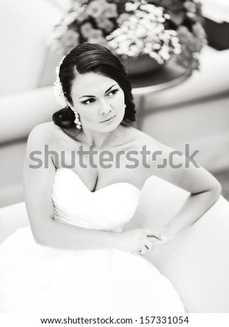 Beautiful young bride in summer cafe, black and white.