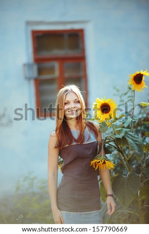 Teenage beautiful girl with sun flower. Summer picture.