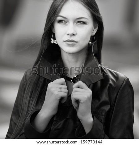 Closeup street portrait of young beautiful woman in black and white.