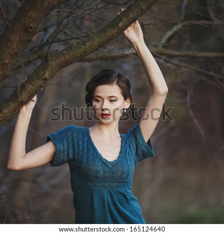 attractive  woman with retro coiffure  in autumn garden