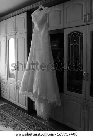Picture of wedding dress hanging in flat, black and white.