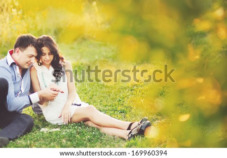 Caucasian young couple having date, spending great time in garden on summer sunny day.