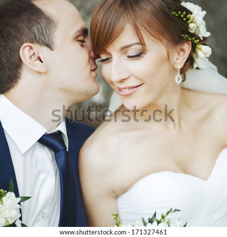 Symbol of togetherness.  Young caucasian wedding couple embracing.