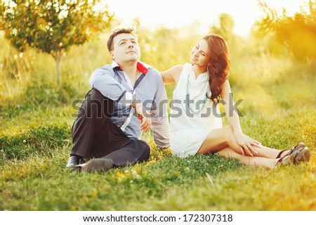 Young couple having date, spending great time in garden on summer sunny day.