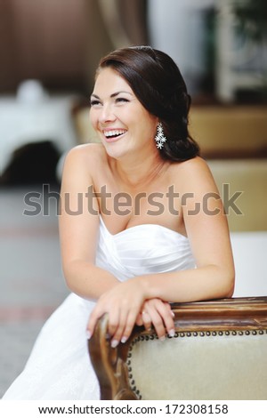 Happy bride sitting in restaurant.