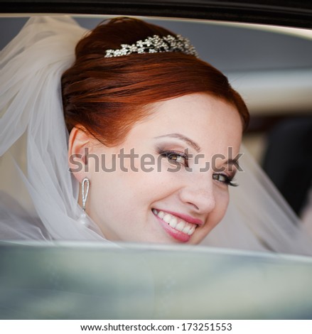 Lovely red hair bride in white limo.