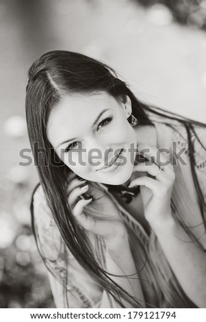 Black and white street portrait of young long hair brunette woman