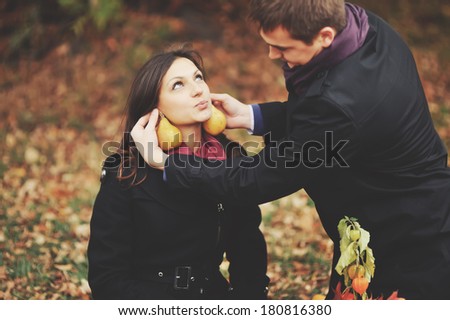 Pear ear-ring is very cute.  Young couple having fun in autumn park.