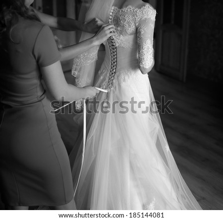 Happy bridal morning. Bride getting ready. Black and white wedding picture.