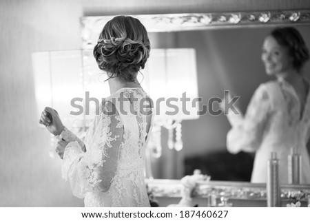 Happy bridal morning. Bride getting ready. Black and white wedding picture.