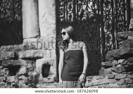 Beautiful teenage girl in sunglasses. Summer picture in black and white.