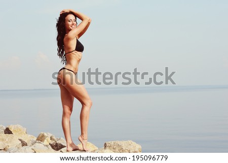 Fitness lady. Sexy woman at seaside. Great ass.