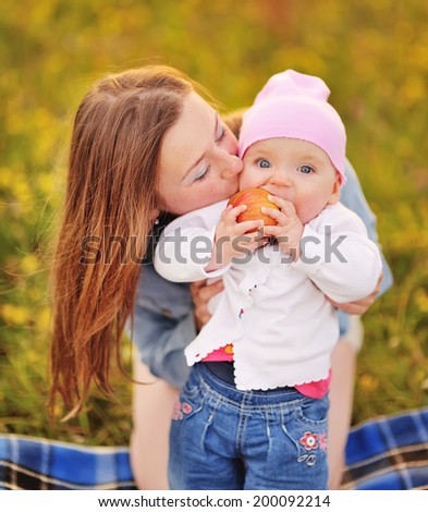 Happy family, mom and lovely daughter. Sunny summer weather.