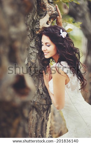 Young beautiful bride enjoying walking in magic forest