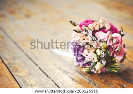 Wedding bouquet on wood surface. Summer wedding.